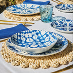 kompozycja z wykorzystaniem niebieskich talerzy mirage ustawionych na okrągłym stole i plecionek podkładce